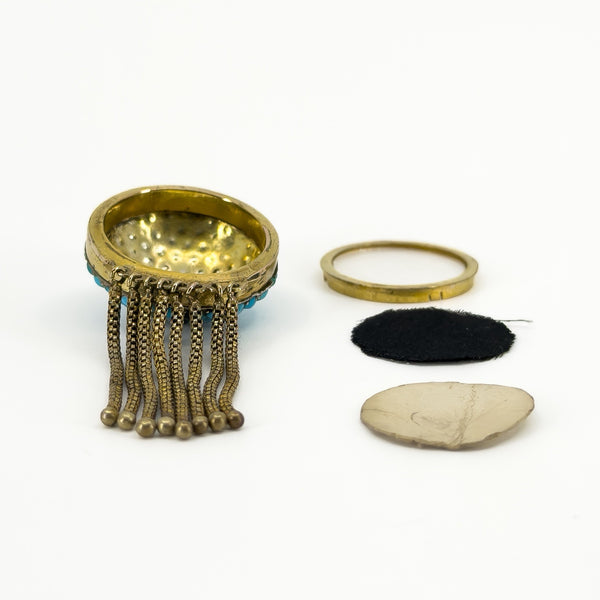 Open reverse of the Victorian 18ct gold tassel locket showing the removable keepsake compartment components.