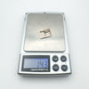 Digital scale displaying 1.43g weight of antique 9ct gold buckle charm