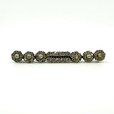 Front view of antique sterling silver bar brooch with clear paste stones and pearl clusters.