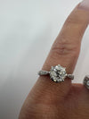Antique platinum old-cut diamond solitaire ring worn on the finger with engraved shoulders visible