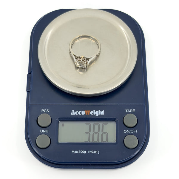 Antique platinum old-cut diamond solitaire ring shown on digital scales weighing 3.86g