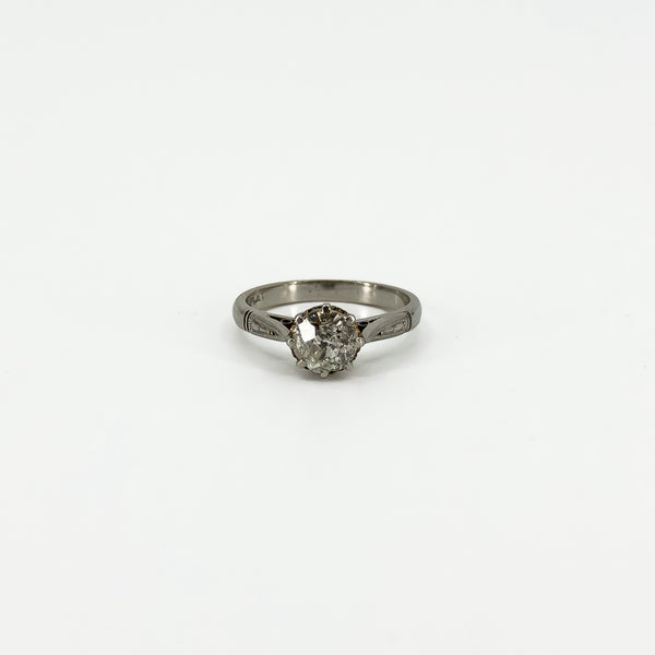 Front view of antique platinum old-cut diamond solitaire ring with engraved shoulders