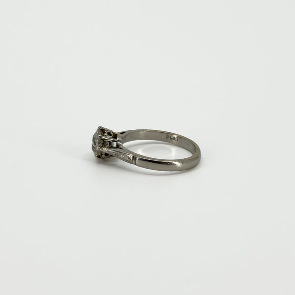 Side profile of antique old-cut diamond solitaire ring with PLAT mark visible inside the band