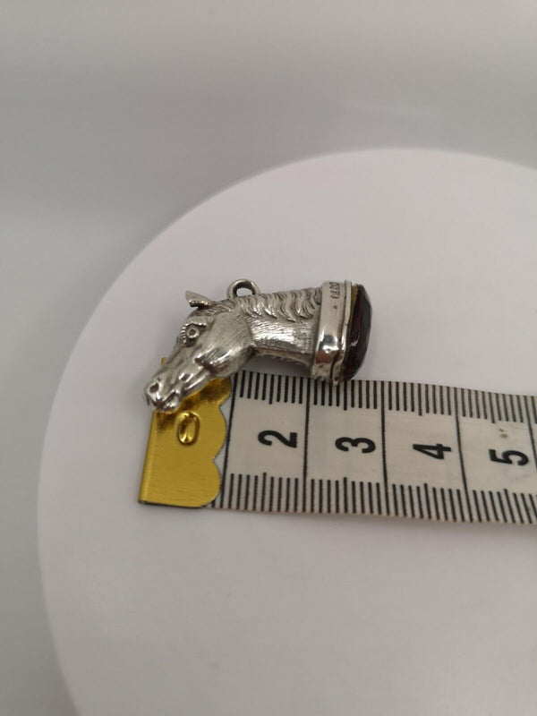 Antique sterling silver horse head pendant set with amethyst, shown with tape measure for size reference, Birmingham 1876
