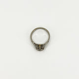 Top view of antique platinum diamond solitaire ring showing open gallery and engraved shoulders