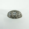 Close front view of Art Deco platinum diamond trilogy ring with filigree openwork