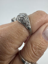 Side view of Art Deco platinum diamond filigree ring worn on the hand