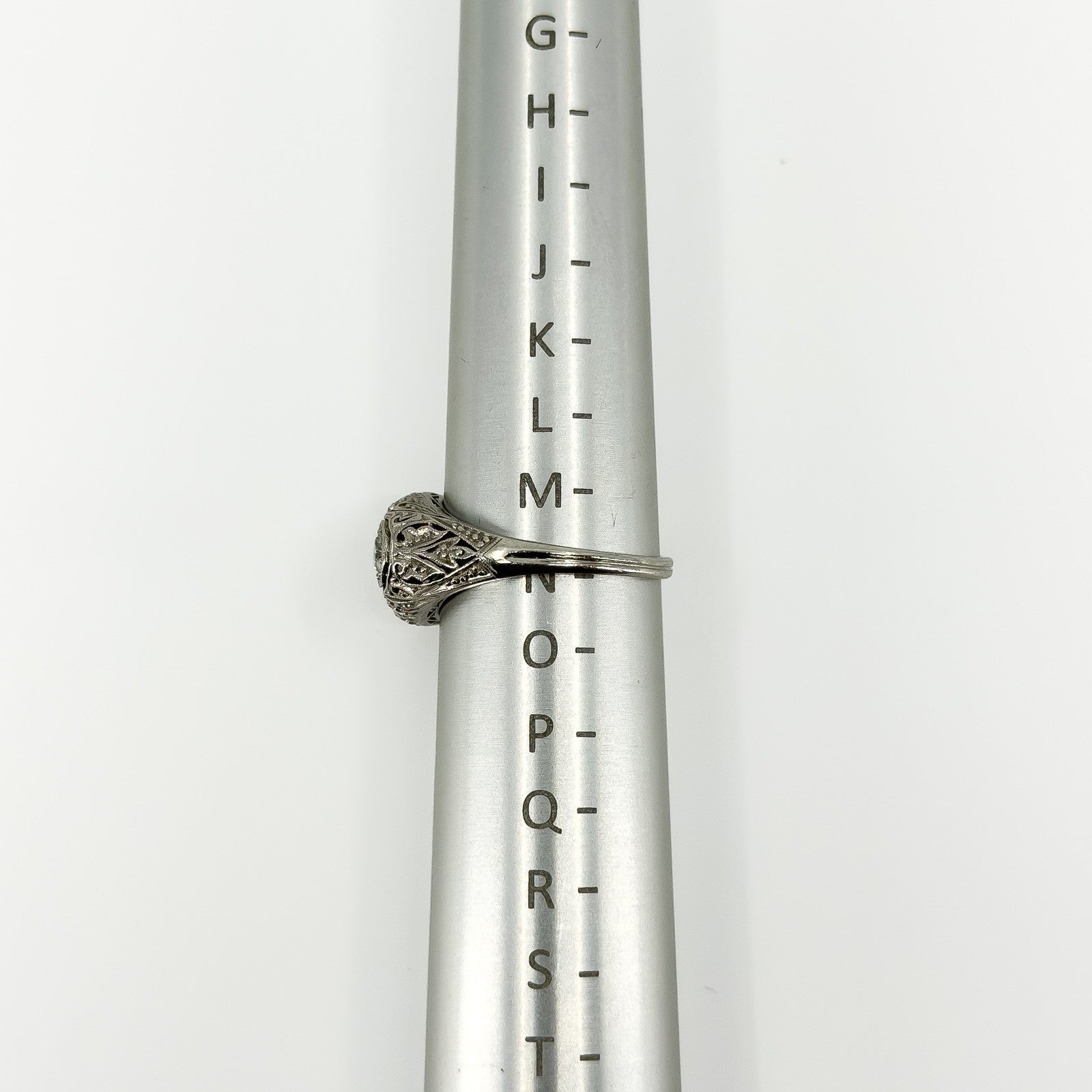 Side view of Art Deco platinum diamond ring on a metal ring sizing mandrel