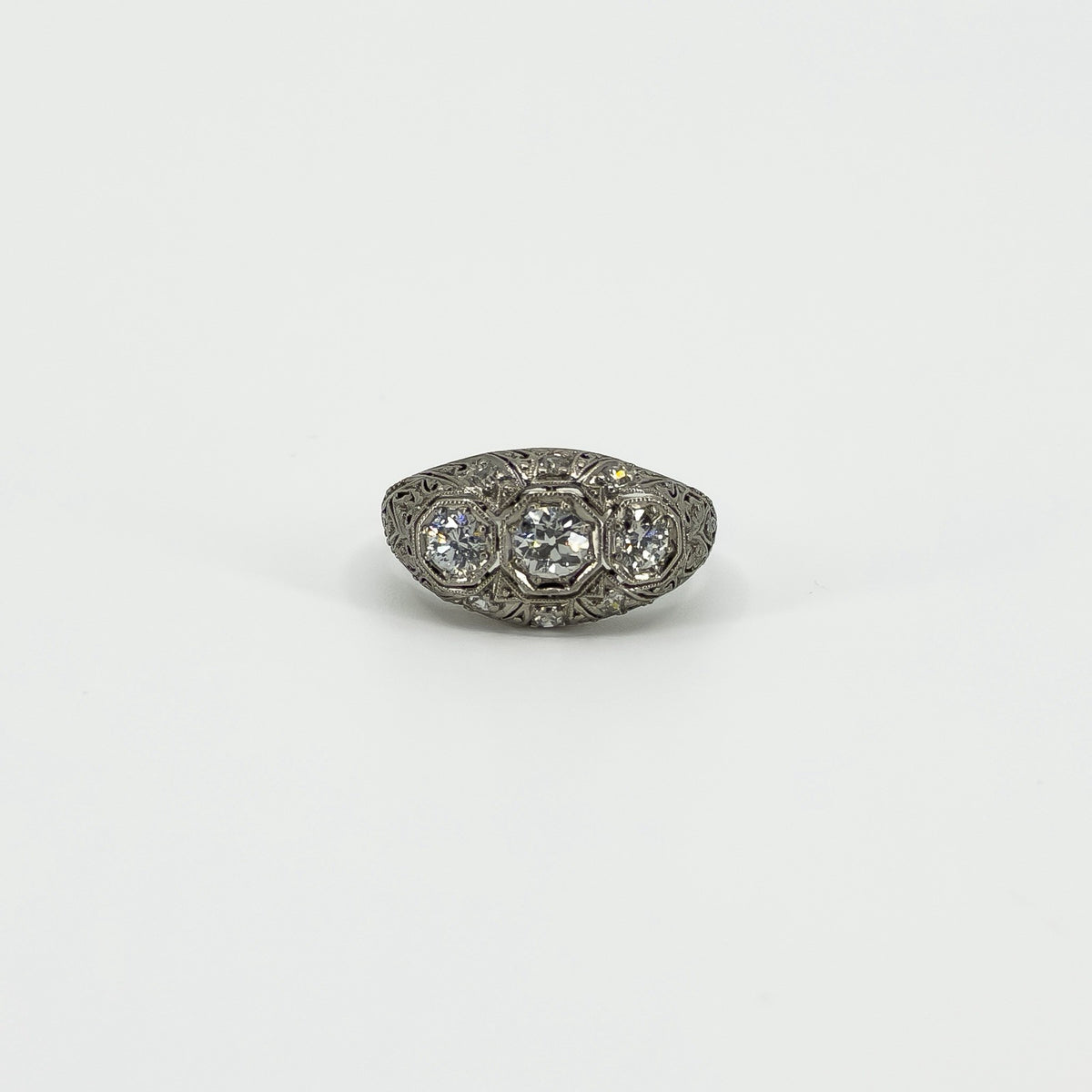Front view of Art Deco platinum 1ct diamond trilogy ring on a white background