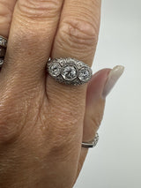 Art Deco platinum diamond trilogy ring worn on the hand showing its front profile
