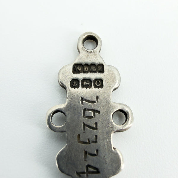 Macro view of a St Johns Ambulance examination bar showing hallmarks and stamped number 262324.