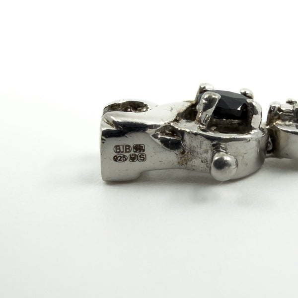 Close up of BJB, 925, London leopard head and date letter S hallmarks on silver bracelet