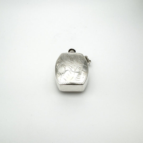 Reverse view of engraved sterling silver perfume bottle pendant with floral detail