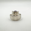 Back view of modernist ring showing thick silver band and amethyst setting