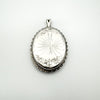 Reverse of oval locket with starburst engraving and scalloped border