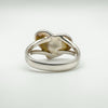 Underside of sterling silver ring showing back of heart setting