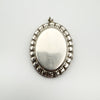 Plain back view of vintage oval sterling silver locket with smooth finish