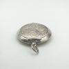 Reverse side of the secret locket pendant with engraved detail and hinge view