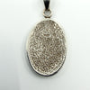 Rear of oval pendant showing textured finish and “925” stamp on sterling silver jewellery.