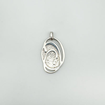 Reverse side of sterling silver green enamel oval pendant with swirly detail