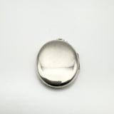 Close-up of plain reverse side of chunky oval sterling silver locket