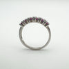 Straight back view showing prong settings and pink garnet stones through the open gallery