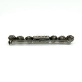 Back of sterling silver paste and pearl bar brooch showing pin and rolling C clasp fitting.