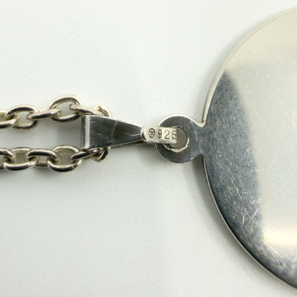 Close-up of the pendant bail stamped 925 on the sterling silver History of Ireland necklace.