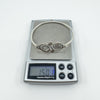Sterling silver mother of pearl bangle shown on digital scale weighing 15.01g