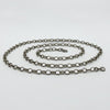 Low angle view of a vintage sterling silver belcher chain necklace laid flat with clasp visible
