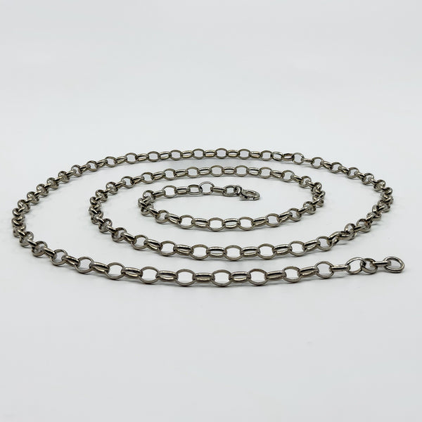 Low angle view of a vintage sterling silver belcher chain necklace laid flat with clasp visible