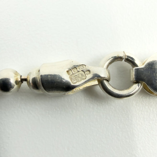 Close-up of CC, 925 and anchor Birmingham hallmark stamps on the clasp fitting.