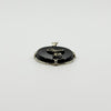 Low back view of black onyx bow pendant showing the oval reverse, white gold frame and bail.