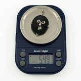 Vintage 14ct white gold black onyx and diamond bow pendant shown on scales weighing approximately 5.49g.