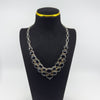 Sterling silver black onyx necklace shown on display bust with oval chain links and cabochon stones