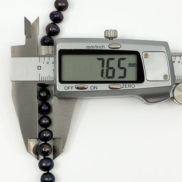 Black freshwater pearl on necklace measured at approximately 7.6mm with digital callipers