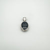Glossy black agate cabochon set in thick silver frame on reversible pendant