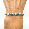 Blue CZ tennis bracelet with X links worn on wrist