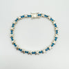 Full view of blue CZ tennis bracelet in sterling silver with X links