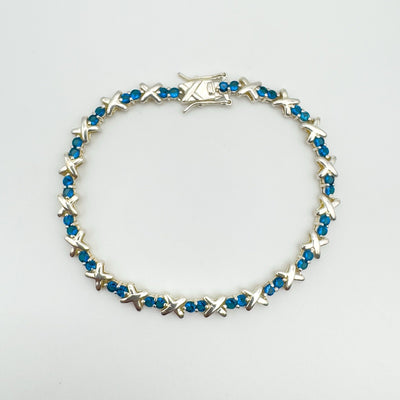 Full view of blue CZ tennis bracelet in sterling silver with X links