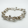 Close-up of tactile sterling silver bracelet with ball and twist link design