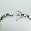 Push clasp with double safety catches on blue CZ tennis bracelet