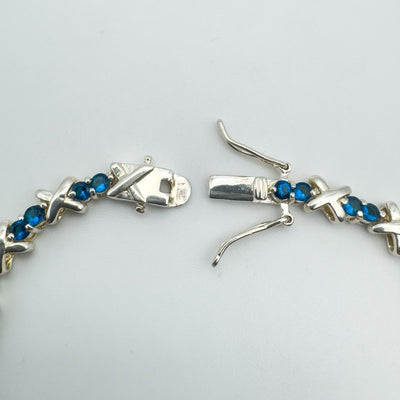 Push clasp with double safety catches on blue CZ tennis bracelet