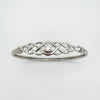 Well-lit front-facing view of Celtic bangle with centred cubic zirconia