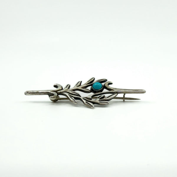 Profile view of vintage sterling silver turquoise brooch showing the C hook clasp and pin.