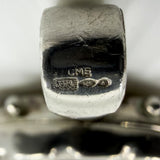 Close up of CME, 925 and triangle import marks on the vintage sterling silver oval locket bail