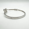 Side profile of sterling silver bangle with oval setting and CZ