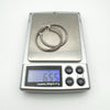 Sterling silver CZ hoop earrings on digital scale showing combined weight of 6.55g