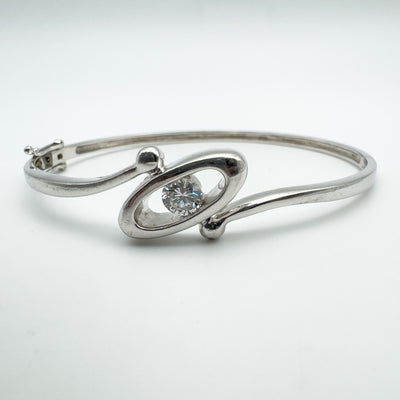Front view of sterling silver oval bangle with 0.50ct round CZ stone