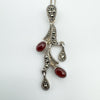 Close-up of marcasite floral detailing and cabochon carnelian stones
